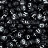 Black bead w/ white letter
